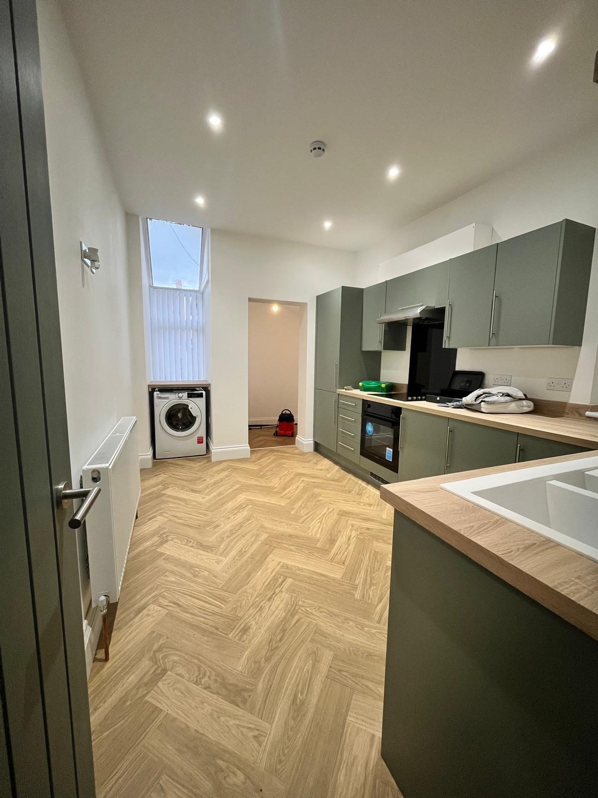 Fitted kitchen with herringbone flooring